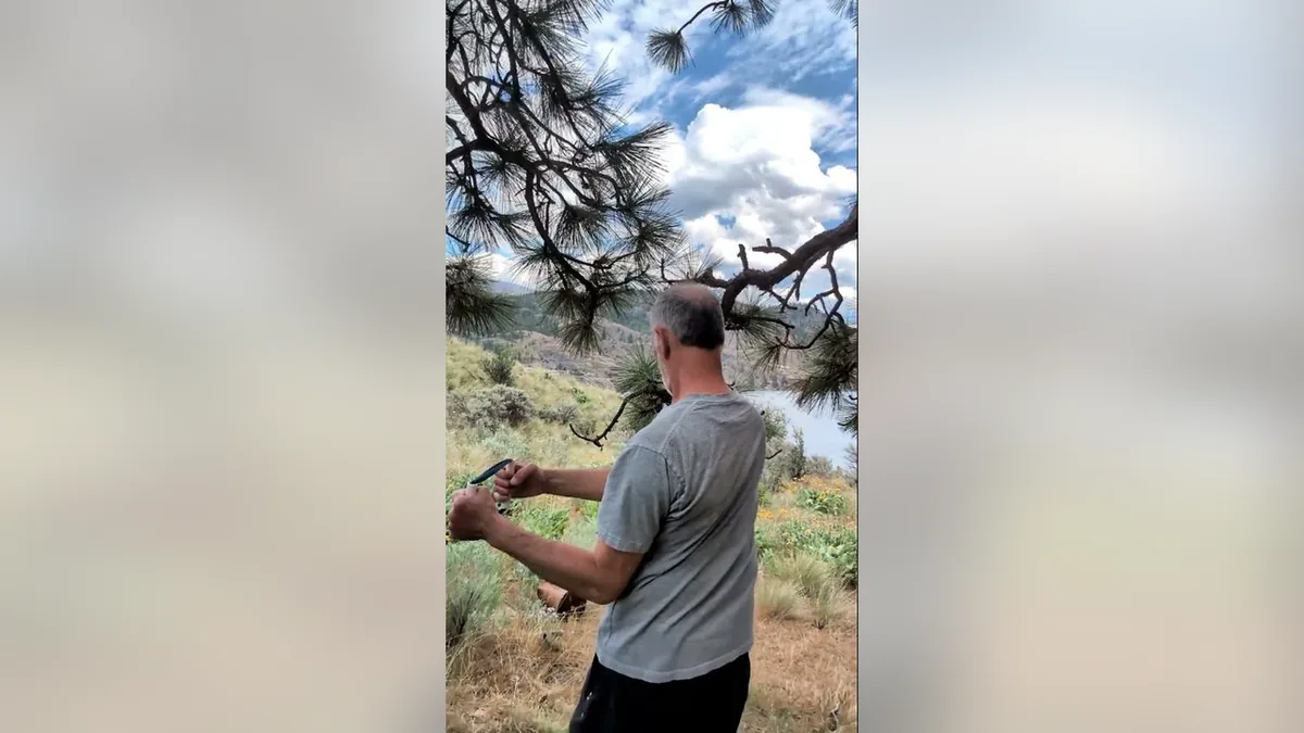 Van demonstrating the Open The Door.Jpg movement with the ShoulderBack Pro outdoors — a frame from the routine video