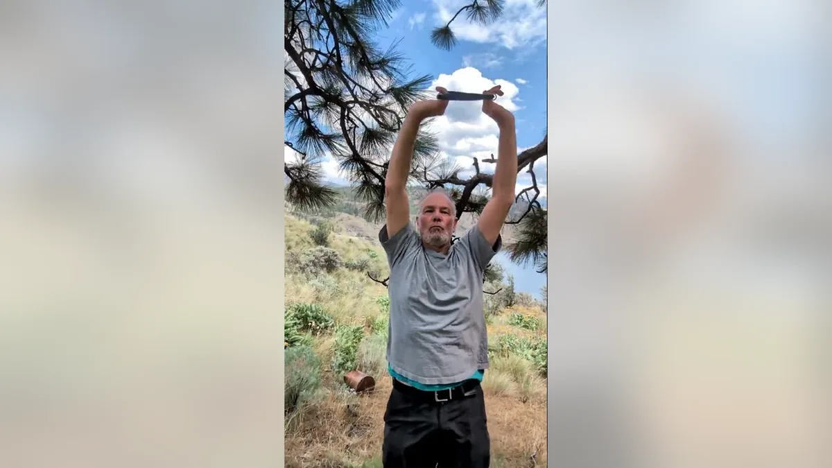 Van demonstrating the Around The World.Jpg movement with the ShoulderBack Pro outdoors — a frame from the routine video