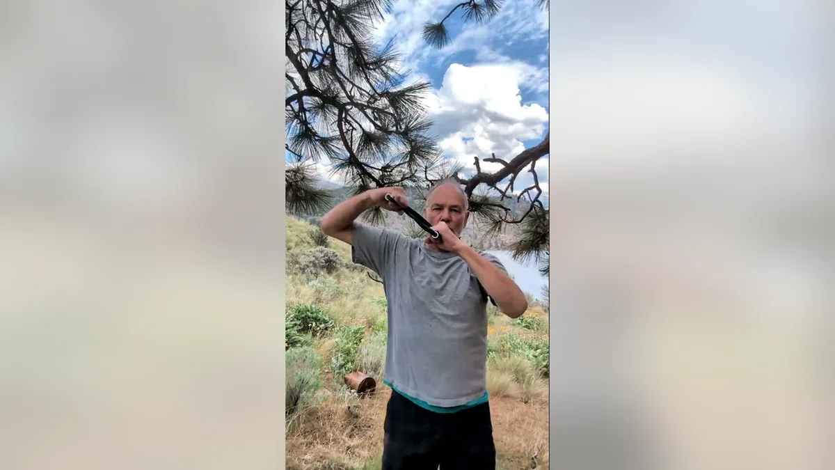 Van demonstrating the Crosscuts.Jpg movement with the ShoulderBack Pro outdoors — a frame from the routine video