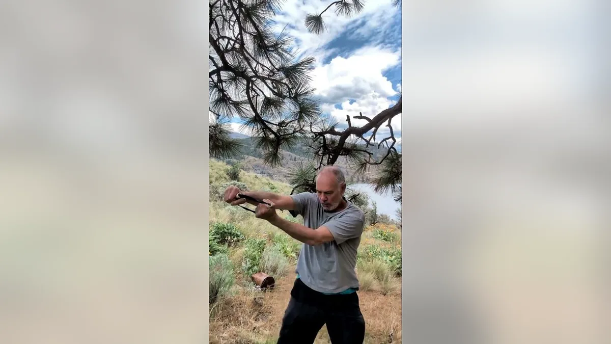 Van demonstrating the Boxing.Jpg movement with the ShoulderBack Pro outdoors — a frame from the routine video