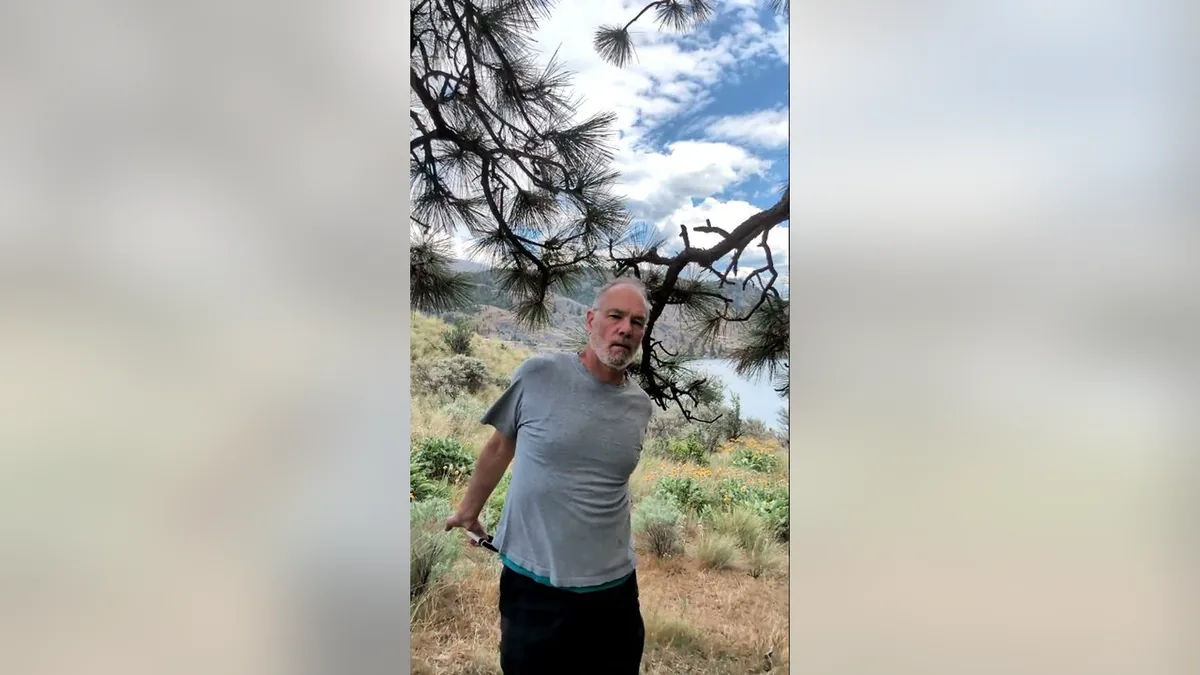Van demonstrating the Resisting Arrest.Jpg movement with the ShoulderBack Pro outdoors — a frame from the routine video